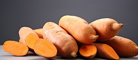 Poster - Fresh sweet potatoes on a white background. copy space available