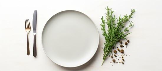 Poster - Grey empty ceramic plate with herbs knife and fork on salty white background Minimal design Space for text or menu. copy space available
