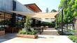 © nitiroj - Elegant cantilever pole supporting a large shade sail in a contemporary outdoor cafe setting