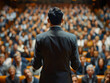 © Piyapat - Rear view of businessman giving a presentation to a large audience in an auditorium. Focus on presenter, colorful, professional setting with crowd.
