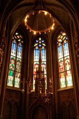 Wall Mural - Little altar in front of colorful stained glass windows in gothic style shape inside the Matthias Church, Budapest, Hungary