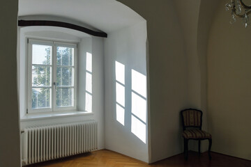 Wall Mural - Empty interior of a old house with reflections of sunlight through the window with blinds