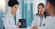 © peopleimages.com - Doctors, tablet and brain scan for team discussion with results, report and review with questions at clinic. Group, women and man with digital touchscreen, feedback and collaboration for neurology