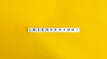 Wall Mural - Bienvenido (Welcome) in Spanish Banner. Text on Block Letter Tiles on Yellow Background. Minimal Aesthetics.