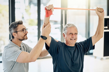 Canvas Print - Smile, physiotherapist and old man with resistance band, stretching and senior healthcare rehabilitation. Physio, caregiver and elderly patient for mobility training, exercise and help in retirement.