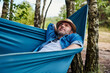 © baranq - Man in hammock relaxing