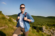 © baranq - Happy man hiking with backpack