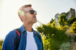© baranq - Portrait of male hiker with sunglasses looking at the view