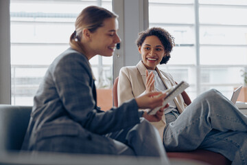 Wall Mural - Woman office worker discussing new project with colleague during working day in coworking