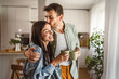 © Miljan Živković - Boyfriend and girlfriend enjoy their first morning coffee at kitchen