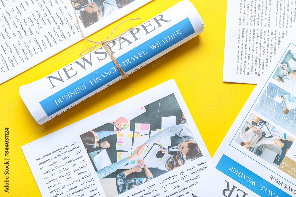 Different newspapers on yellow background