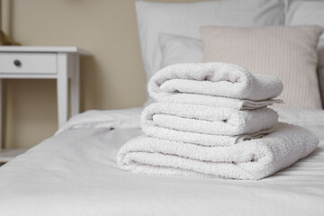 Wall Mural - Stack of clean towels on bed in room, closeup