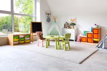 Poster - Interior of light playroom with toys, teepee and chalkboard in kindergarten