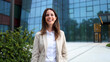 © PeopleVideos - Portrait of a beautiful, young businesswoman enjoying outside, in front of her company building