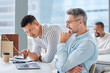 © Abrahams/peopleimages.com - Teamwork, men and laptop in discussion with mentor for help, opinion and advice on report at desk. Employer support, feedback or proposal for project, collaboration and idea for planning in office