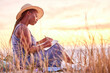 © peopleimages.com - Sunset, diary and black woman journaling in nature to relax on vacation, adventure or holiday. Mental health, ideas and African female person writing notes, feelings or emotions on weekend trip.