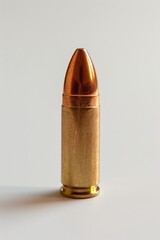 Wall Mural - A close-up shot of a bullet on a white surface, useful for illustrating firearms or ammunition in various contexts