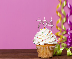 Birthday Cupcake With Candles Lit Forming The Number 794