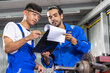 © Art_Photo - Two engineers collaborating on project in industrial setting, reviewing documents and discussing technical details teamwork, engineering and industrial operations with machinery and tool manufacturing