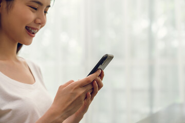 Aufkleber - Close-up of hand holding smartphone device and typing text message on online social.
