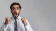 © Ari - Arabian businessman in white shirt raised fist with surprise face