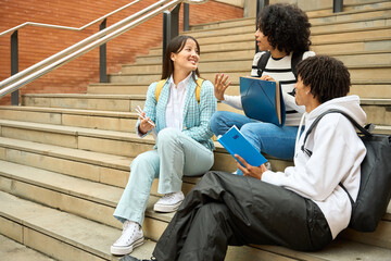 Wall Mural - three young multiethnic students having fun