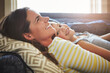 © ReadyAtTheEase/peopleimages.com - Love, smile and mother cuddle her child while relaxing on sofa in the living room of their home. Happiness, bonding and young mom embracing and her laughing daughter with care in their family house