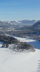 Wall Mural - Vertical aerial video view from drone flying over the winter forest road on the bank of river Katun.