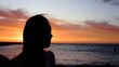 © BJP7images - Head and shoulders, silhouette of young woman a sunset. Beautiful orange colors. Copy space