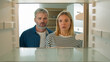 © Yuliia - Point of view POV from inside refrigerator Caucasian adult family mature couple middle-aged man woman open empty fridge have nothing to eat sad upset with poor poverty unemployment starvation hunger