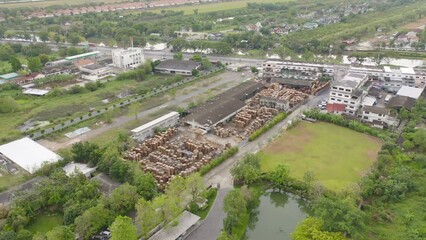 Wall Mural - Aerial top view of wood industry factory in urban city town. Business distribution logistic transport in Thailand.