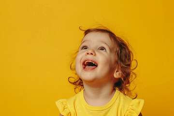 Wall Mural - A young girl with curly hair is smiling