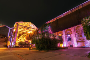 Wall Mural - Factory buildings and industrial equipment in the evening