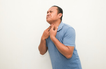 Asian adult man feels sore throat
