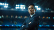 © NaphakStudio - A professional Japanese manager stands with arms crossed in a stadium, exuding confidence and leadership. The stadium lights create a dramatic backdrop.
