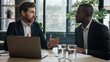 © Yuliia - Two diverse businessmen multiracial men at office with laptop. Caucasian financial advisor manager consultant insurance agent consulting African American man client talk show business presentation