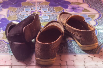 still life photography : leather shoes and black woman shoes on floor, valentine's day concept