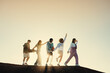 © Jacob Lund - Group of friends having fun during a gap year travel adventure at sunset