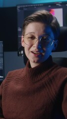 Fototapete - Young female video editor records for blog, talks about films color correction. Software interface with color wheels and movie footage on computer monitor and big screens. Color grading control panel.