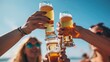 © earthstudiotomo - Group of friends toasting with beer glasses at an outdoor celebration on a sunny day, enjoying festive moments together.