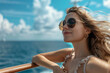 © Dennis - A happy young blond woman with sunglasses enjoying her vacation on a cruise ship, she is standing at the railing, enjoying the view over the ocean