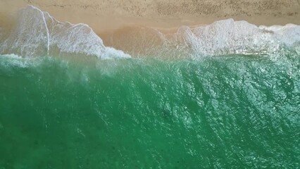 Wall Mural - Aerial view of sea waves breaking on sand tropical beach, slow motion, 4k