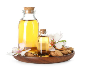 Bottles of almond oil, fresh nuts and beautiful flowers isolated on white