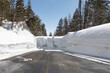 © Pete Niesen Photo - Road closed signs are buried deep in a wall of snow making a road impassable in the high sierras