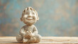 © Kiss - Ugly stone sculpture of happy and cute Asian child meditating on wooden tabletop with blue background