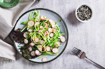 Poster - Fresh vitamin salad of cucumber and radish on a plate on the table top view