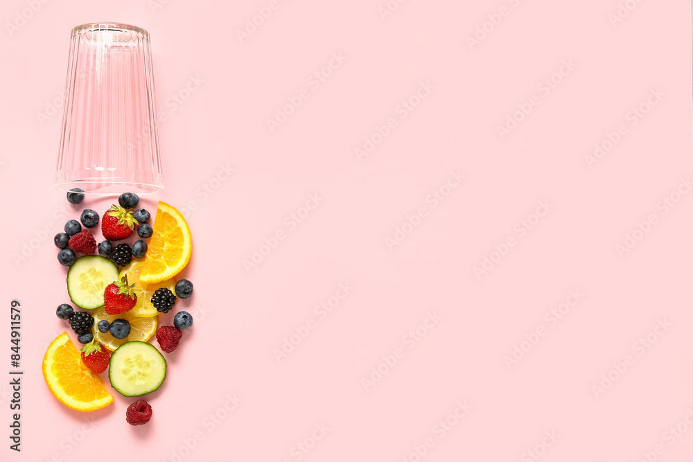 Composition with glass and ingredients for fresh lemonade on pink background