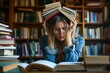 © juliars - Overwhelmed young woman balancing stack of books on her head in a library