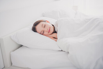 Sticker - Portrait of charming cute adorable girl lying sleeping enjoying comfy bed sweet dreams white light room interior indoors