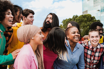 Multiethnic young people having fun together outdoor - Diverse friends youth community